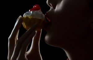 Arabella sexily licking a cream cake